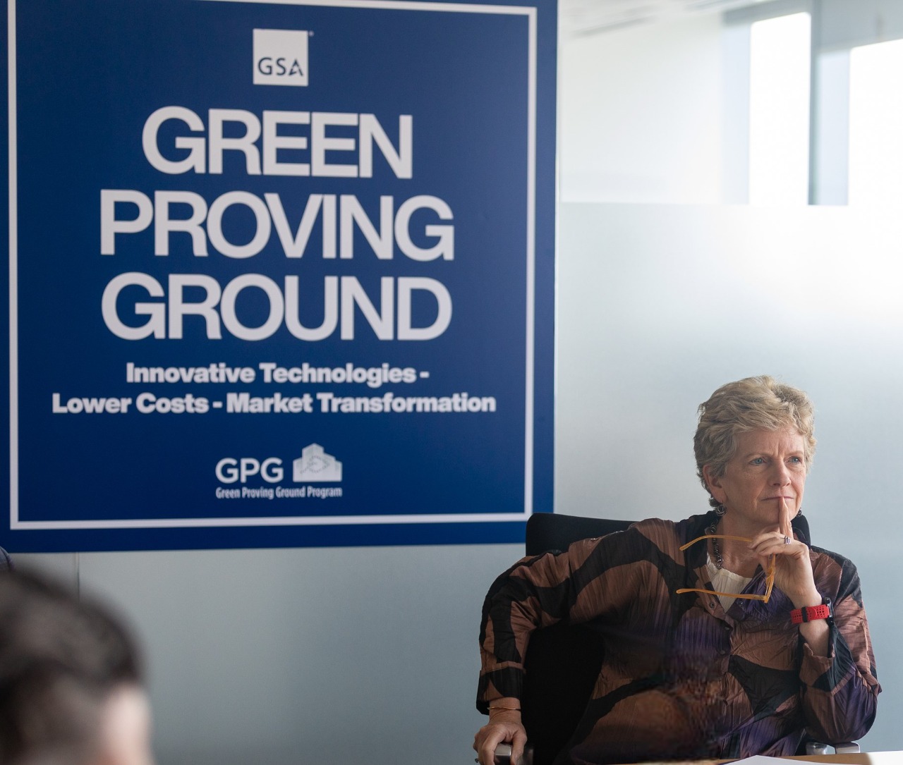 GSA Administrator Robin Carnahan listening intently with her glasses held in her left hand