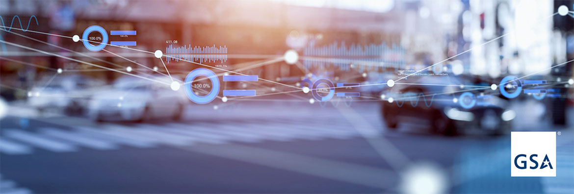 Blurry background of a street corner, with data and symbols and technology markings in the foreground