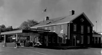 a brick building with cars under the car pot