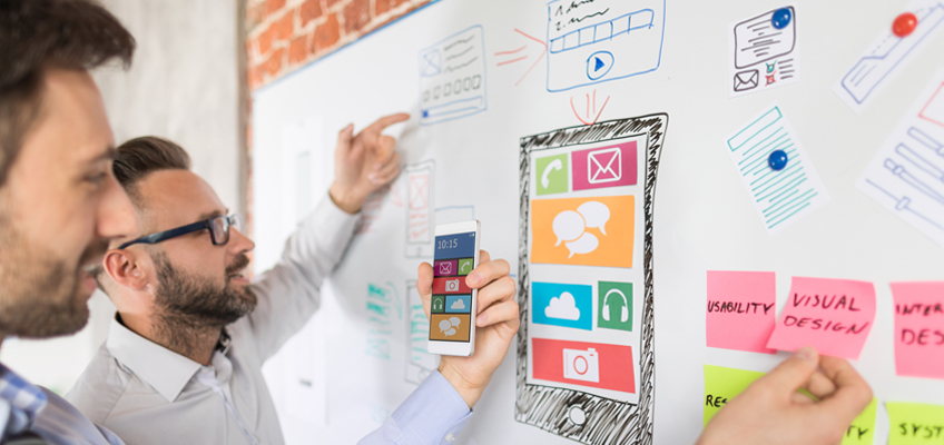 two men brainstorming on whiteboard