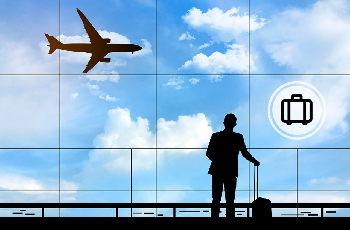 A figure looking out of a large window with a plane flying by