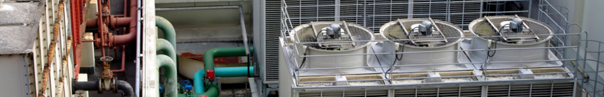 Image of several different color building pipes and three white air conditioning units.