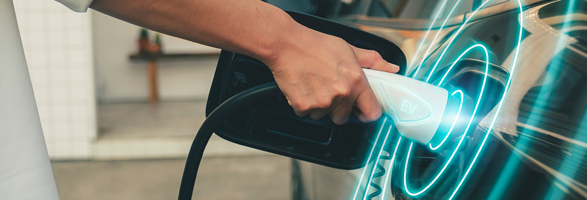 Electric Vehicle being plugged into a charging station