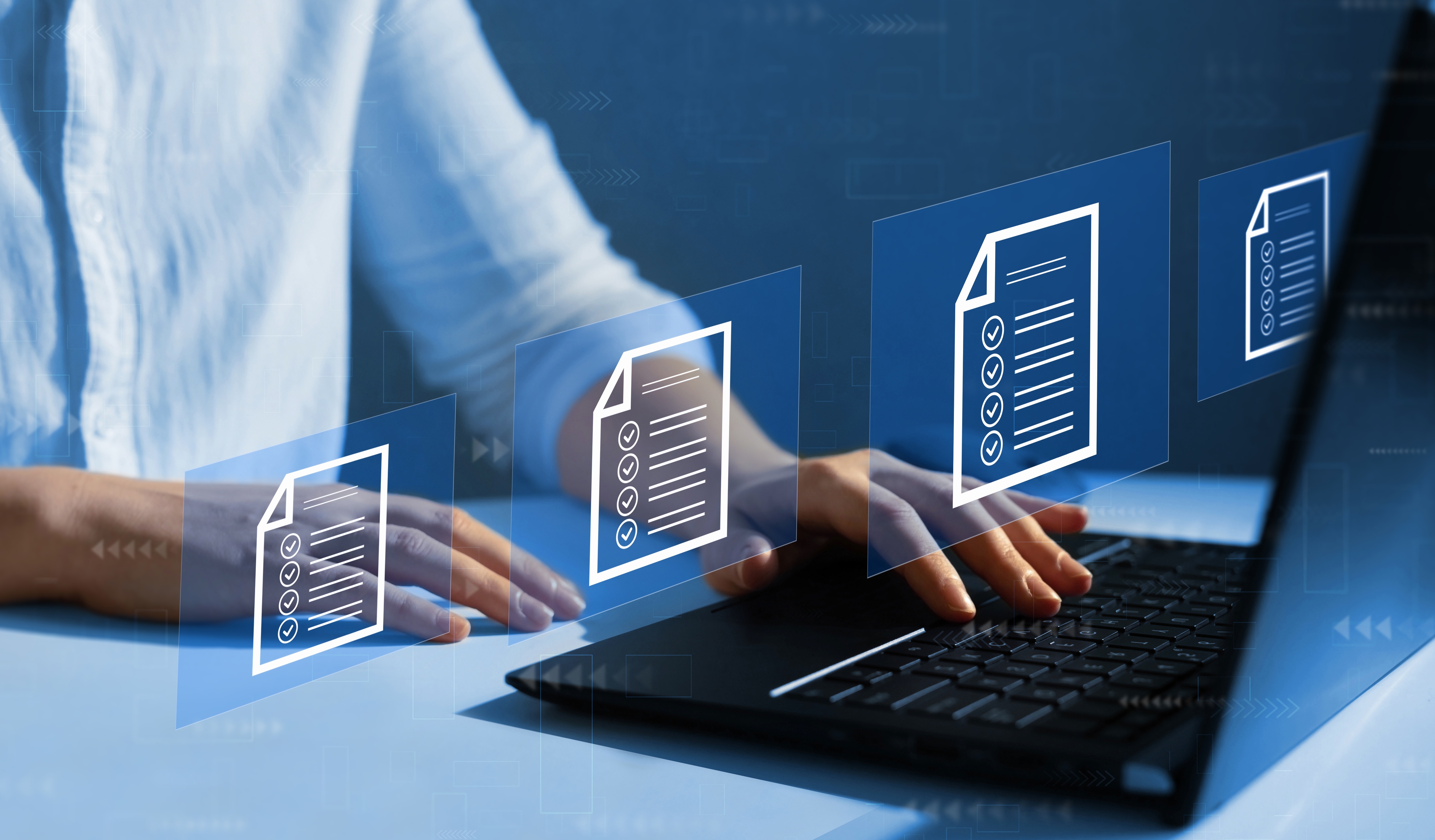 Image of man at computer with digital documents