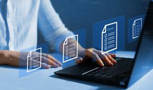 Image of man at computer with digital documents