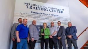 image of union multiple people in front on an sign 