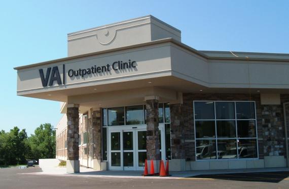 The exterior of a building with a sign that says "VA outpatient clinic" in black letters