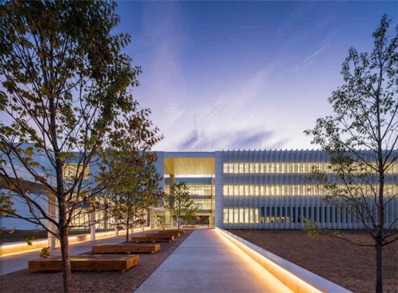 Exterior view of a three level modern building at evening time