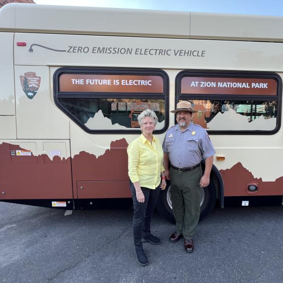 Woman and man standing in front of bus