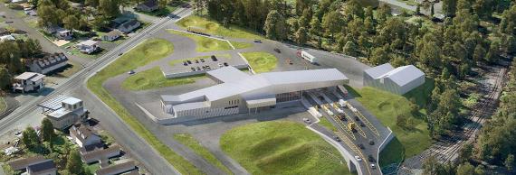 Aerial 3D rendering of group of low buildings among grass, trees and roads, the largest building having a canopy with checkpoints for several lanes of traffic