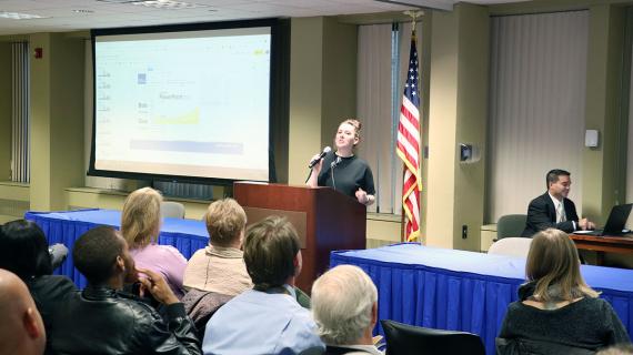 Woman in black with microphone at lectern