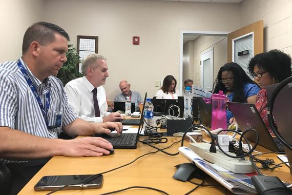 Four people working around a table