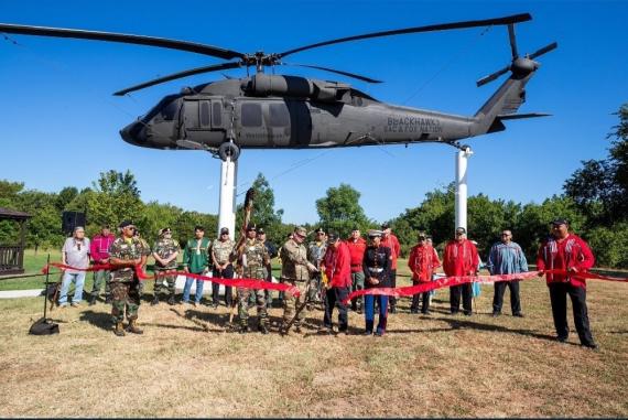 Black hawk helicopter monument. Standing in front of the monument are Sac and Fox Veterans and leaders.