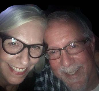 Two people smiling in a selfie photo.