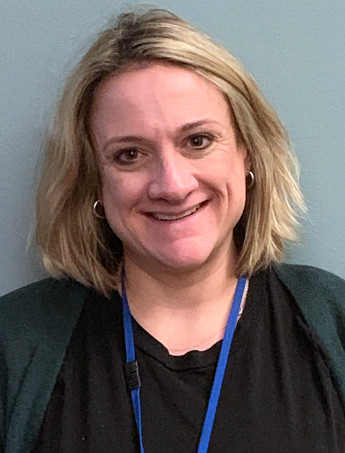 A person wearing a black shirt smiling.