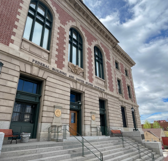 he front of the Mike Mansfield Federal Building and U.S. Courthouse with sloping stairs.