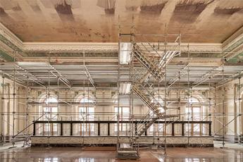 Complex scaffolding rising up to the central ceiling panel