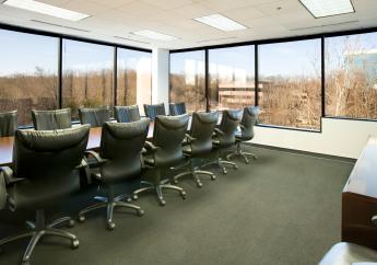 Long shot of conference room with outside scene in the background