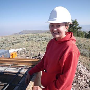 R8 Kali Schmitt working while wearing a white hard hat