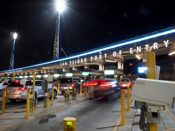 Minimal light art installation of blue and white lights that spas the San Ysidro port of entry canopy