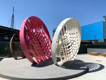 Outdoor sculpture of three large perforated disks