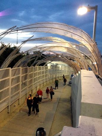 Bridge walkway at night with people