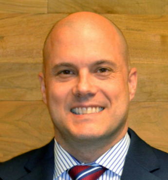 Tony D. Russell - bald, white man (headshot) with suit and tie