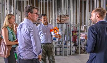 (From left to right) White House Climate Team members Cara Carmichael, Andrew Mayock, and Tanuj Deora listen to a presentation b