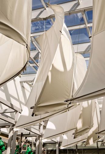 Art installation of sails in a large glass-enclosed room
