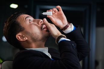 Man putting in eyedrops