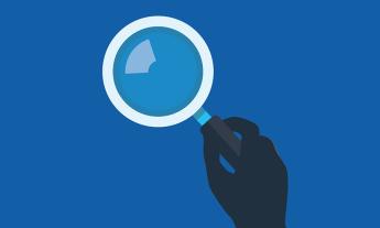 Illustration of hand holding a magnifying glass