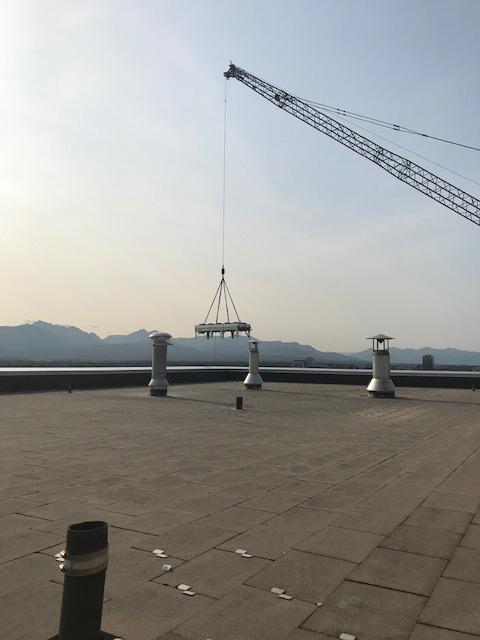 Chiller with crane clearing roof edge