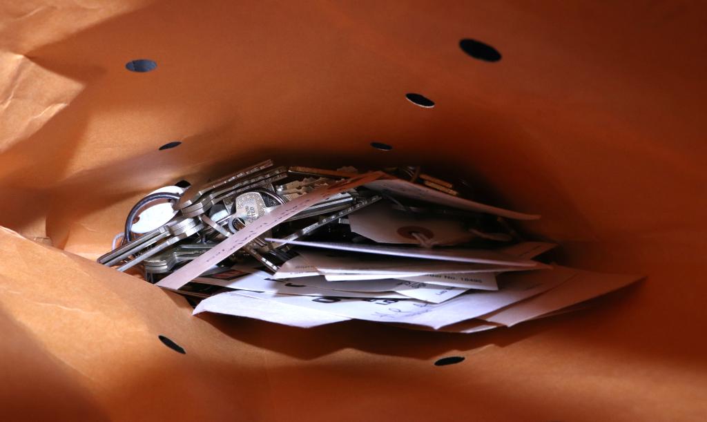 An envelope full of metal keys and tags