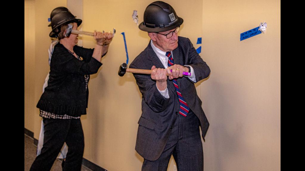 An attendee to the wall breaking event strikes a wall with a ceremonial hammer to commemorate the start of construction at the Frank E. Moss U.S. Courthouse. Photo by Richard Stebbins