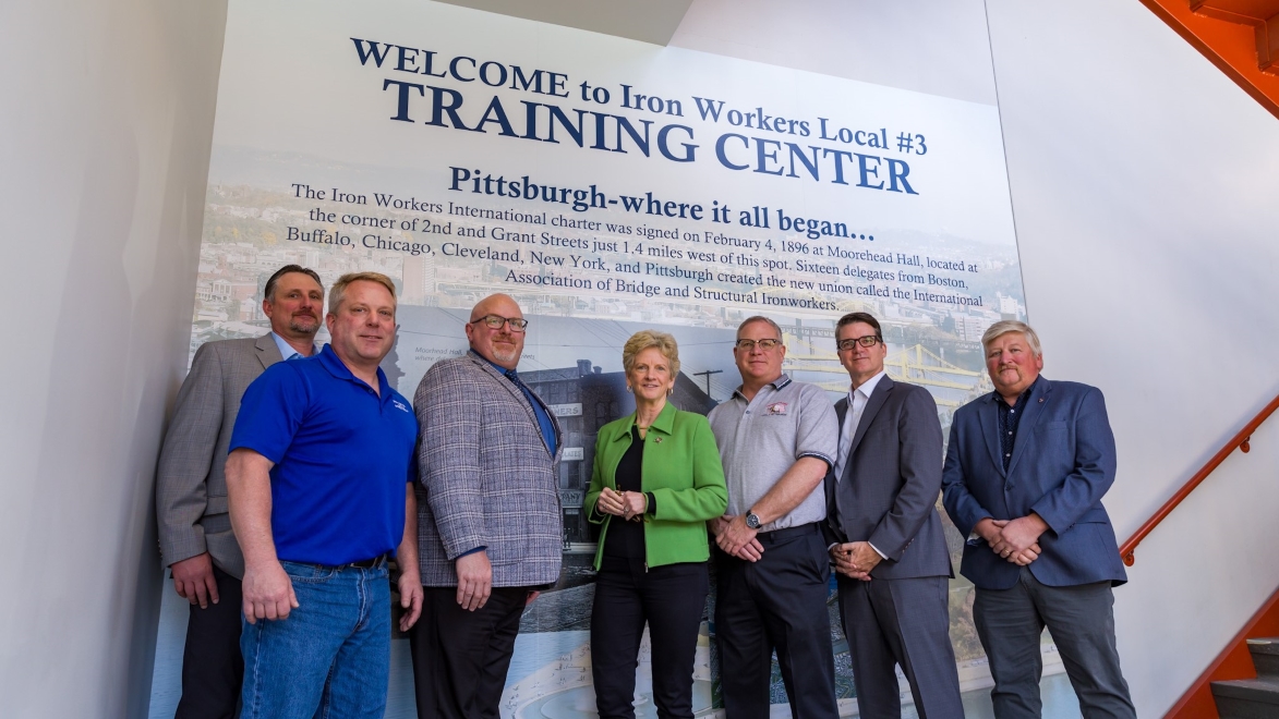image of union multiple people in front on an sign 